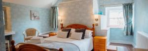 a bedroom with a bed with blue walls and a window at Celtic Haven in Tenby