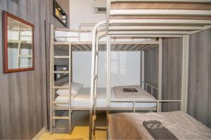A bed or beds in a room at The Cabin Tanjung Yogyakarta
