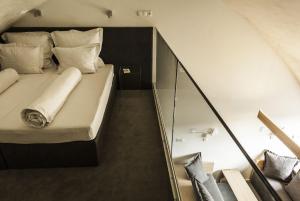 a large bed in a room with a staircase at HOT_elarnia Hotel & Spa in Puszczykowo