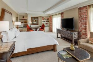a bedroom with a large white bed and a television at The Westin Riverwalk, San Antonio in San Antonio
