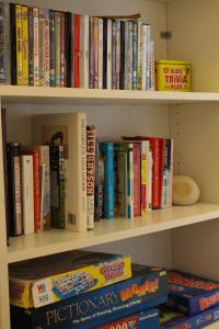 a book shelf filled with lots of books at "Sea Suite" Tenby in Tenby