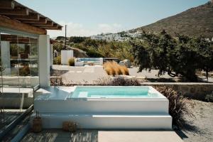 a swimming pool in front of a house at Luxury Cycladic Villa with Seaview and MiniPool in Naxos Chora