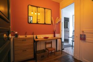 a bathroom with a sink and a mirror on the wall at Cozy love cocoon in Boulogne-Billancourt's heart in Boulogne-Billancourt