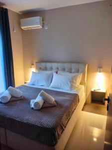 a bedroom with a large bed with towels on it at Villa ArGia with private pool in Georgioupoli +36 photos