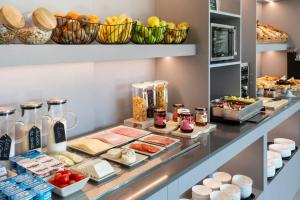 a buffet with many different types of food on display at B&B HOTEL Guimarães in Guimarães