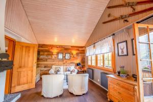 a room with a table and chairs in a tiny house at Chalet La Neuf in Blitzingen