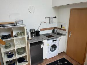 cocina con lavadora y fregadero en Schöner Anbau mitten in Hennef, 