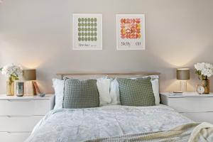 a bedroom with a bed with two white night stands at Brand New 1-Bed Flat With Free Parking in Nottingham