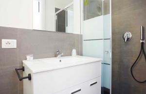 a bathroom with a white sink and a shower at Stabilimento Lido Burrone in Favignana