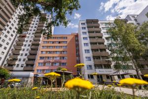 a group of buildings with yellow flowers in the foreground at Hotel Lützow in Berlin