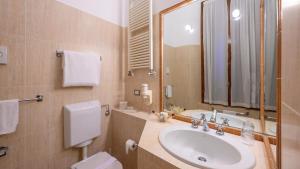 a bathroom with a sink and a toilet and a mirror at Hotel Posta in Reggio Emilia +79 photos