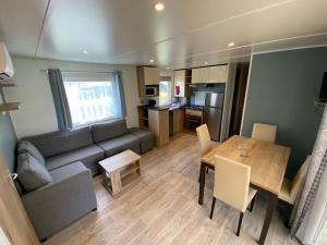 a living room with a couch and a table at 318 Emplacement prestige à Mer et Soleil 5* in Les Sables Vignier