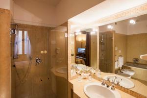 a bathroom with a sink and a shower and a sink at Hotel Posta in Reggio Emilia +82 photos