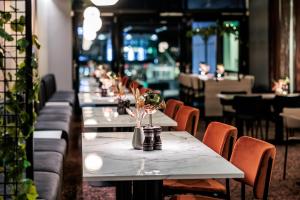 a row of tables in a restaurant with chairs at Quality Hotel Saga in Troms&oslash;