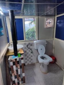 a small bathroom with a toilet and a sink at Rajeswari Ac Dormitory For Indian males only in Port Blair