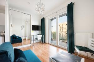 a living room with a couch and a large window at New Varsovia Comfort 310 in Warsaw
