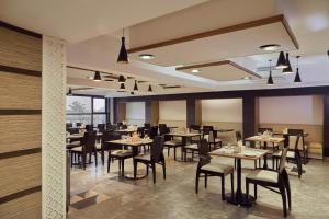 A restaurant or other place to eat at Hotel Orion Centrally near North Goa & Panjim