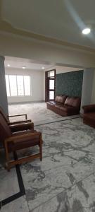 a large living room with couches and a couch at OYO Flagship 89130 Kohsheen Guest House 