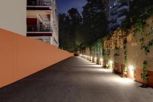 an empty street with lights on the side of a building at Lemon Tree Suites, Whitefield, Bengaluru in Bangalore