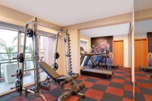 a fitness room with tread machines and a gym at Lemon Tree Suites, Whitefield, Bengaluru in Bangalore