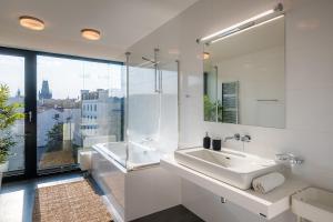 a white bathroom with a sink and a large window at 5BR+2Bath Old Town Industrial Penthouse, A/C in Prague
