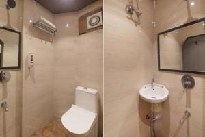 a bathroom with a toilet and a sink at FabHotel Royal Palm Inn in Faizābād
