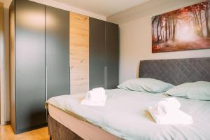 sypialnia z łóżkiem z ręcznikami w obiekcie Luxury Suite - Therme ED - Messe MUC - Parken - WLAN w mieście Erding