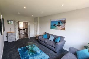 a living room with a couch and a table at Cornish Village Getaway in Gwennap