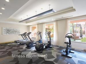 a gym with treadmills and ellipticals in a room at Hotel The Celestine Tokyo Shiba in Tokyo