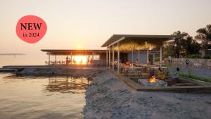 a restaurant on a dock next to the water at Terra Park Phalaris in Novalja