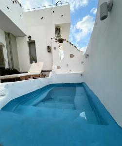 a swimming pool in the middle of a house at Sonia`s luxury apartment with jacuzzi in Kamilari