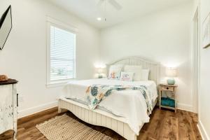 a white bedroom with a bed and a window at Boats Fishing and Exquisite Decor in Freeport