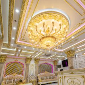 a room with a ceiling with a chandelier and beds at Khách Sạn Cường Thanh 3 in Ho Chi Minh City