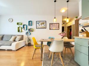 a kitchen and living room with a table and chairs at Corvin City Apartment - FREE PARKING- in Budapest