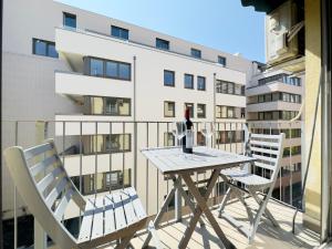 a table and chairs on a balcony with a building at Corvin City Apartment - FREE PARKING- in Budapest