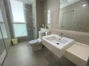 a white bathroom with a sink and a toilet at Sutera Avenue Kota Kinabalu in Kota Kinabalu