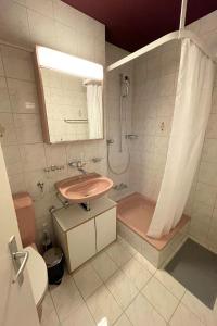 a bathroom with a sink and a shower and a toilet at Apartment 302 - Zentrales Studio in Engelberg