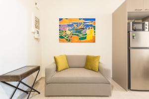 a living room with a couch and a refrigerator at Over The Town Urban 1BR Apt. 7' to Thiseio Metro in Athens