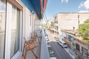a balcony with chairs and a view of a street at Over The Town Urban 1BR Apt. 7' to Thiseio Metro in Athens