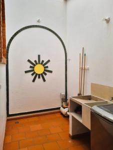 a kitchen with a door with a sun painted on it at Hermosa y Acogedora Casa de Descanso & Mirador in Barichara +33 photos