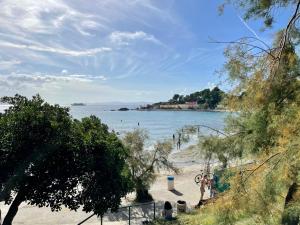 a beach with people on the sand and a body of water at Apartment “Jelin dvor” 3+2, Bacvice, Split in Split