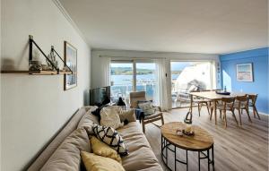 a living room with a couch and a table at Beautiful Apartment In Uggdal With House Sea View in Uggdal