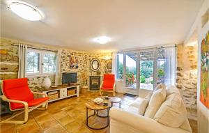 a living room with a white couch and red chairs at Gorgeous Home In Fontarches With Kitchen in Fontarèches