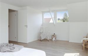 a white room with a bed and a window at Amazing Home In Lammhult With Ethernet Internet in Lammhult