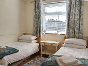 a room with two twin beds and a window at Why Not in Canterbury