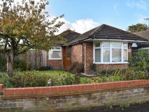 a brick house with a garden in front of it at Why Not in Canterbury