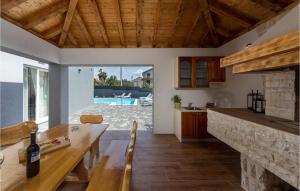 a kitchen and living room with a wooden table and a counter at Villa Bibinje in Bibinje +34 photos