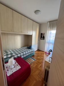 a small room with two beds and a table at La nostra casa la vostra casa Cir00023 in Saint Vincent