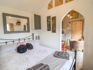 a bedroom with a bed and a mirror at Chateau Petit in Caersws