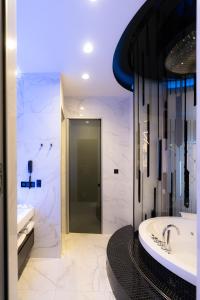 a bathroom with a tub and a sink and a toilet at Tsarsky Hotel in Kyiv